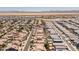Expansive aerial view of a suburban neighborhood featuring well-maintained homes and community spaces in a sunny desert setting at 36197 W Cartegna Ln, Maricopa, AZ 85138