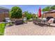 Charming backyard patio area, perfect for relaxation and outdoor dining, with lush greenery enhancing the serene ambiance at 36197 W Cartegna Ln, Maricopa, AZ 85138