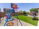 Spacious backyard showcasing a play area and well-maintained artificial grass, ideal for outdoor activities at 36197 W Cartegna Ln, Maricopa, AZ 85138