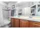 Elegant bathroom featuring a double vanity, tile shower, and modern fixtures at 36197 W Cartegna Ln, Maricopa, AZ 85138