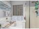 Bright bathroom features tiled walls, a soaking tub with a shower, and a unique glass block window at 36197 W Cartegna Ln, Maricopa, AZ 85138