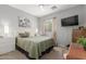 Cozy bedroom featuring a comfortable bed, soft lighting, and calming artwork at 36197 W Cartegna Ln, Maricopa, AZ 85138