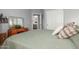 Bright bedroom with a large bed, dresser, and ensuite bathroom access at 36197 W Cartegna Ln, Maricopa, AZ 85138