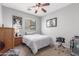 Neutral bedroom with a comfortable bed, drum set, and natural light at 36197 W Cartegna Ln, Maricopa, AZ 85138