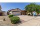 Charming single-story home with stucco and stone accents, tile roof, and a well-manicured front yard at 36197 W Cartegna Ln, Maricopa, AZ 85138