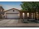 Charming single-story home with stucco and stone accents, tile roof, and a well-manicured front yard at 36197 W Cartegna Ln, Maricopa, AZ 85138
