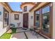 Inviting front porch with seating, decor, and stylish front door at 36197 W Cartegna Ln, Maricopa, AZ 85138