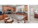 Well-equipped kitchen with a large island, stainless steel appliances, and a breakfast bar with seating for casual dining at 36197 W Cartegna Ln, Maricopa, AZ 85138