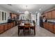 Expansive kitchen includes a large island, stainless appliances, and ample cabinets for plenty of storage; dining area adjacent at 36197 W Cartegna Ln, Maricopa, AZ 85138