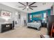 Spacious main bedroom features a ceiling fan, plush bed, and blue accent wall, creating a relaxing retreat at 36197 W Cartegna Ln, Maricopa, AZ 85138