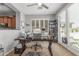 Bright office space with natural light from the windows, complemented by a modern ceiling fan and neutral color scheme at 36197 W Cartegna Ln, Maricopa, AZ 85138