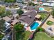 A tranquil backyard with a refreshing pool, covered patio, lush greenery, and a charming playset, perfect for relaxation and play at 4115 W Danbury Dr, Glendale, AZ 85308