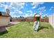 Spacious backyard with a play structure and a grassy lawn, creating an ideal space for recreation at 4115 W Danbury Dr, Glendale, AZ 85308