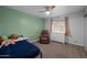 Bright bedroom featuring a ceiling fan, carpeted floors, and a window for natural light at 4115 W Danbury Dr, Glendale, AZ 85308