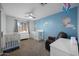 Charming Bedroom featuring two cribs, a dresser and soothing decor at 4115 W Danbury Dr, Glendale, AZ 85308