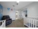 Adorable Bedroom features two cribs, glider and soft decorations at 4115 W Danbury Dr, Glendale, AZ 85308