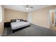 Bedroom features carpeted floors, a ceiling fan, and ample natural light, creating a cozy atmosphere at 4115 W Danbury Dr, Glendale, AZ 85308