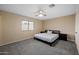 Bedroom boasts carpeted floors, a ceiling fan, and a window, creating a cozy atmosphere at 4115 W Danbury Dr, Glendale, AZ 85308