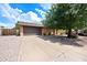 Home with a desert landscape, wide driveway, and a two-car garage at 4115 W Danbury Dr, Glendale, AZ 85308