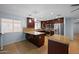 Spacious kitchen features granite countertops, stainless steel appliances, and dark wood cabinetry at 4115 W Danbury Dr, Glendale, AZ 85308