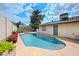 Backyard view of the refreshing pool area, complemented by green landscaping and sunny skies at 4115 W Danbury Dr, Glendale, AZ 85308