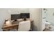 Clean office space with a dark wood desk, office chair, and full bathroom featuring tiled flooring at 5047 N 83Rd St, Scottsdale, AZ 85250