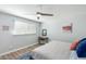 Bright bedroom featuring a ceiling fan, light gray walls, and hardwood floors at 5047 N 83Rd St, Scottsdale, AZ 85250