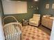 Bedroom with a crib, chair, dresser, and rug at 5047 N 83Rd St, Scottsdale, AZ 85250