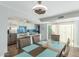 Bright dining area features a modern light fixture and seating for six adjacent to an updated kitchen at 5047 N 83Rd St, Scottsdale, AZ 85250