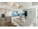 Bright kitchen boasts stainless steel appliances, white cabinetry, blue subway tile backsplash, and an island with bar seating at 5047 N 83Rd St, Scottsdale, AZ 85250
