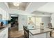 Bright kitchen with stainless appliances, white cabinets, blue subway tile, island seating and adjacent dining and outdoor spaces at 5047 N 83Rd St, Scottsdale, AZ 85250