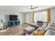 Inviting living room with hardwood floors, large sectional sofa, and a modern ceiling fan at 5047 N 83Rd St, Scottsdale, AZ 85250