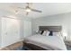 Well-lit bedroom featuring a ceiling fan, neutral walls, wood-look floors, and dual closets with doors at 5047 N 83Rd St, Scottsdale, AZ 85250