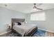 Comfortable main bedroom features a ceiling fan, a large window, and a decorative blue area rug at 5047 N 83Rd St, Scottsdale, AZ 85250