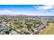 Extensive aerial view of a residential neighborhood with diverse homes, abundant trees, and scenic mountain backdrop at 5052 W Boston S Way, Chandler, AZ 85226