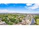 Vast aerial shot of a tranquil neighborhood with tree-lined streets, well-maintained homes, and mountain views at 5052 W Boston S Way, Chandler, AZ 85226