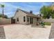 Spacious backyard with a large patio area, artificial turf, and privacy fencing at 5052 W Boston S Way, Chandler, AZ 85226