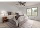Comfortable bedroom features a cozy bed with plush bedding and a ceiling fan at 5052 W Boston S Way, Chandler, AZ 85226
