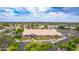 Aerial view of a large building with a tiled roof, surrounded by a parking lot and lush landscaping at 5052 W Boston S Way, Chandler, AZ 85226