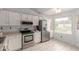 Sunlit kitchen featuring a stainless steel refrigerator and white cabinets at 5052 W Boston S Way, Chandler, AZ 85226