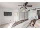 Bedroom with a sliding barn door and a ceiling fan at 5052 W Boston S Way, Chandler, AZ 85226