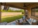 Comfortable covered patio area with ceiling fan, outdoor seating, and views of the grassy backyard at 517 S 165Th Dr, Goodyear, AZ 85338