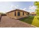 Well-maintained backyard with lawn and gravel, perfect for entertaining and relaxing, with view of community pool at 517 S 165Th Dr, Goodyear, AZ 85338