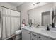 Bright bathroom featuring double sink vanity with white marble countertop and modern black fixtures at 517 S 165Th Dr, Goodyear, AZ 85338