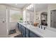 Bathroom featuring double sinks, ample counter space, and a frosted glass window at 517 S 165Th Dr, Goodyear, AZ 85338