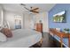 Comfortable bedroom with a warm color scheme, a full bathroom and a dresser at 517 S 165Th Dr, Goodyear, AZ 85338