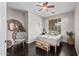 Comfortable bedroom with wood floors, egg chair, and natural light creates a relaxing and inviting space at 517 S 165Th Dr, Goodyear, AZ 85338