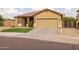 Inviting single-story home featuring a well-kept front yard and attached two car garage at 517 S 165Th Dr, Goodyear, AZ 85338