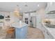 Open kitchen features a large island, stainless steel appliances, and white cabinets at 517 S 165Th Dr, Goodyear, AZ 85338