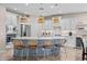 Bright kitchen features a large island with seating, stainless steel appliances, and pendant lighting at 517 S 165Th Dr, Goodyear, AZ 85338